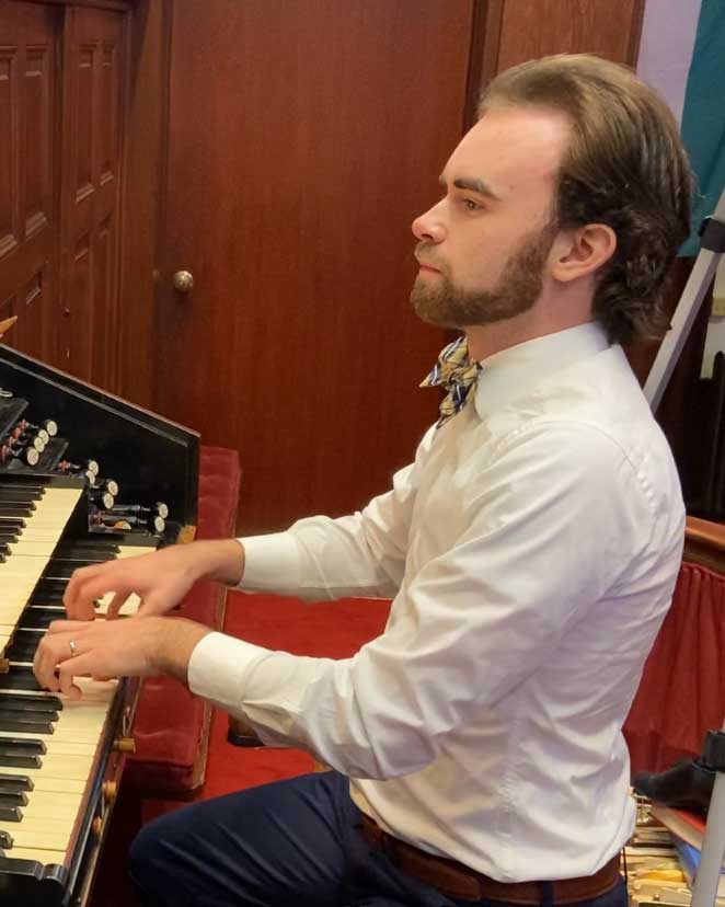 Julian Jenson playing the organ in a church.